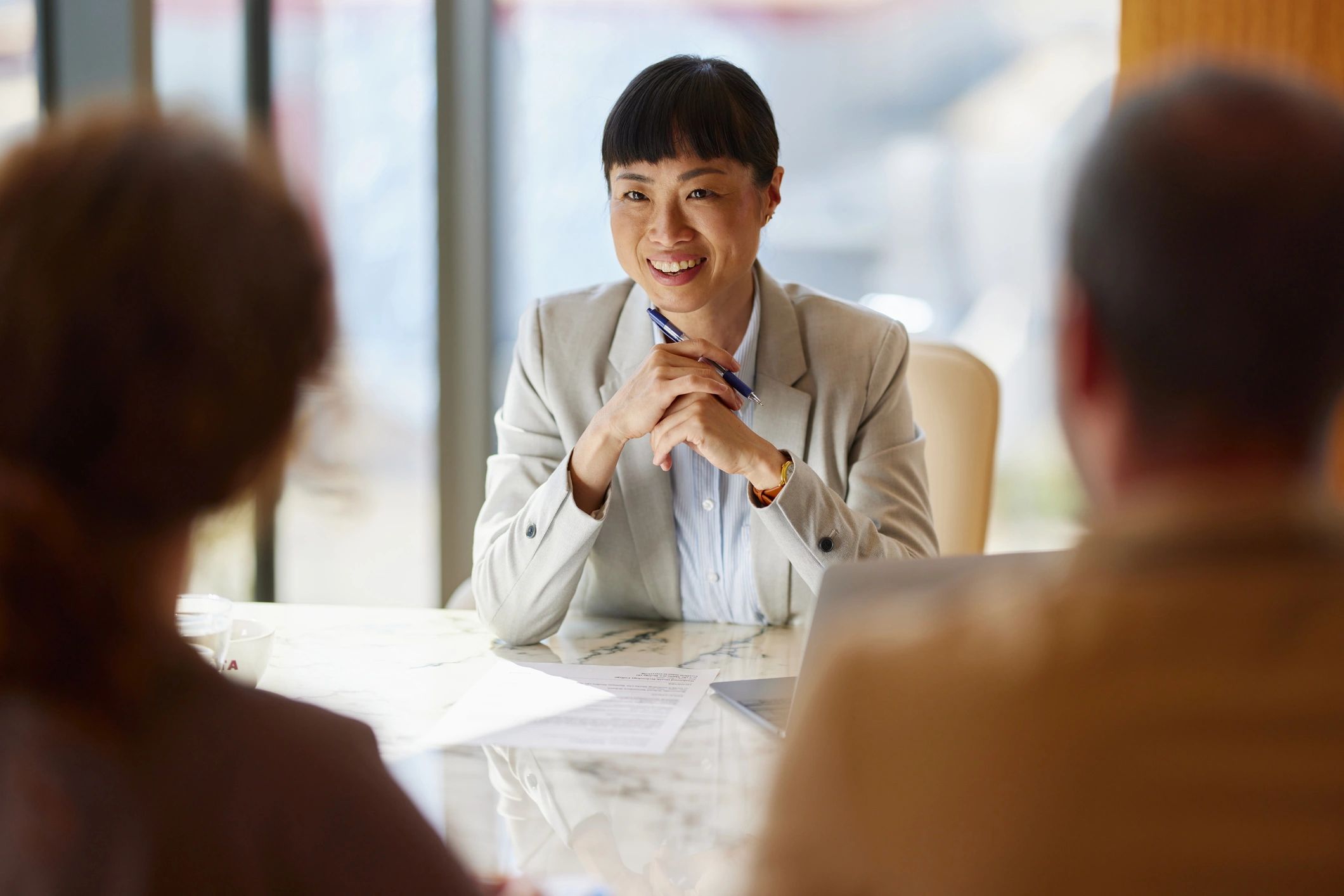 Real estate advisor meeting with clients at a desk