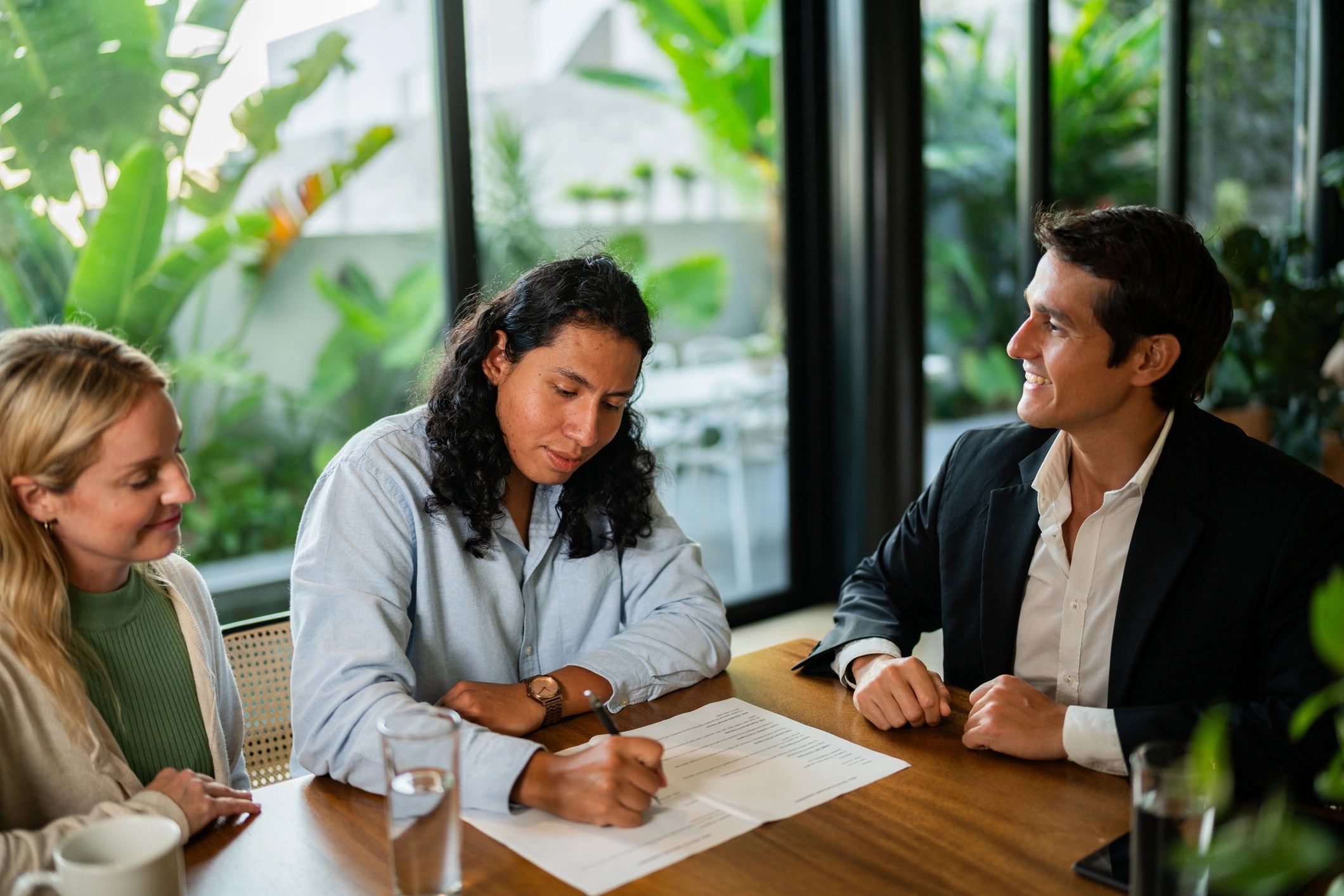 Clients signing documents with a real estate agent